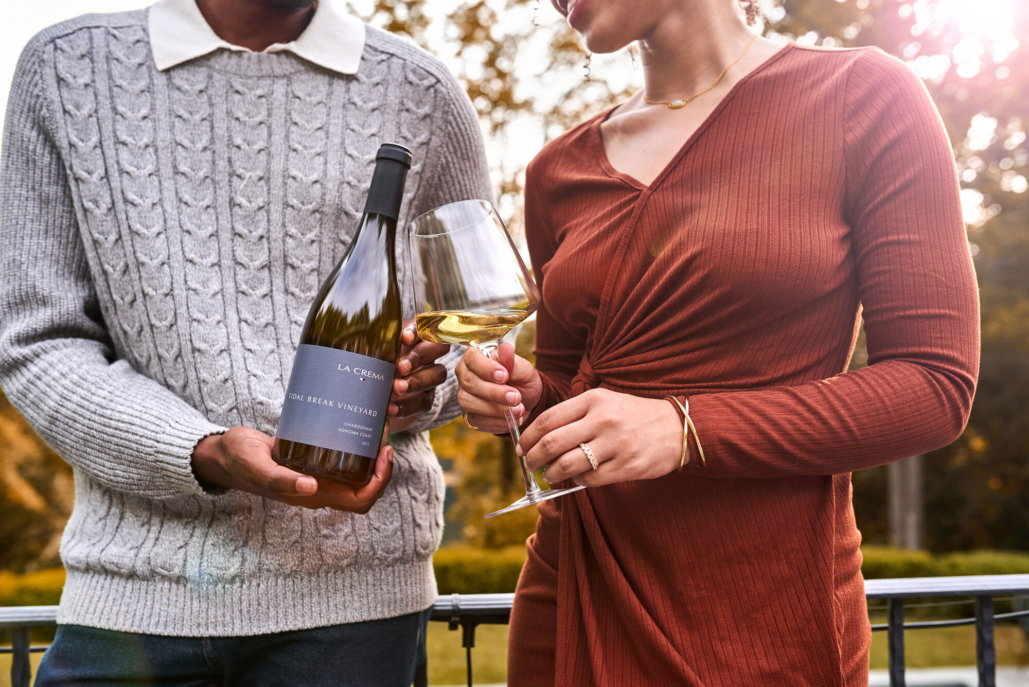 A couple drinking a glass of La Crema Chardonnay outdoors
